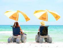 2 beach wheelchairs with umbrellas